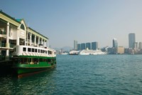 Star ferry on a pier with buildings in the background, Central District, Hong Kong Island, Hong Kong Framed Print