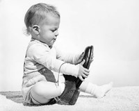 1960s Baby Boy Trying To Put On Man'S Shoe Fine Art Print