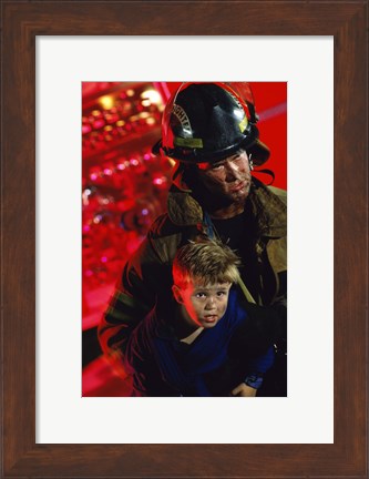 Framed Close-up of a firefighter carrying a boy Print