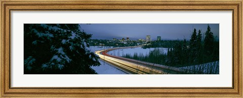 Framed Autumobile lights on busy street, distant city lights, frozen Westchester Lagoon, Anchorage, Alaska, USA. Print