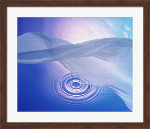 Framed Downward view of ring in lavender water with floating fabric in foreground and brightly lit background Print