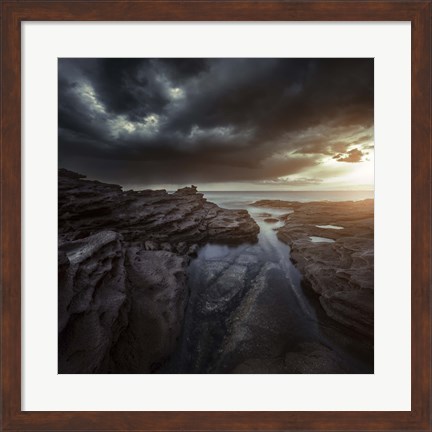 Framed Huge rocks on the shore of a sea against stormy clouds, Sardinia, Italy Print