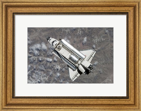 Framed Aerial view of Space Shuttle Discovery over Earth as it approaches the International Space Station Print