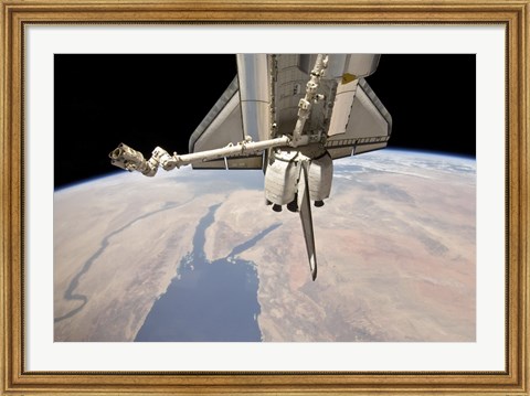 Framed Aft Section of the Docked Space Shuttle Discovery and the Station&#39;s Robotic Canadarm2 Print